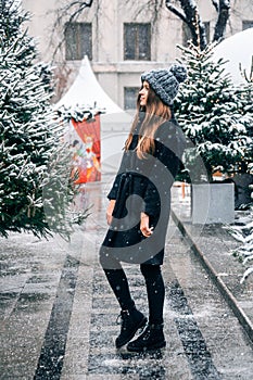 Young beautiful fashion girl is enjoying her time through winter holiday in Christmas evening, Moscow, Tverskaya Square