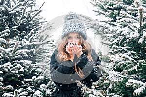 Young beautiful fashion girl is enjoying her time through winter holiday in Christmas evening, Moscow, Tverskaya Square