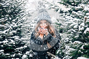 Young beautiful fashion girl is enjoying her time through winter holiday in Christmas evening, Moscow, Tverskaya Square