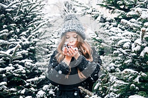 Young beautiful fashion girl is enjoying her time through winter holiday in Christmas evening, Moscow, Tverskaya Square