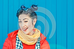 Young beautiful fashion hipster woman with colorful hair winking