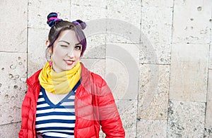 Young beautiful fashion hipster woman with colorful hair winking