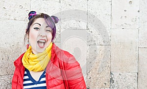 Young beautiful fashion hipster woman with colorful hair winking