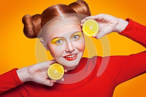 Young beautiful fashion model with Lemon. studio shot.