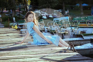 Young beautiful fashion model posing on pier