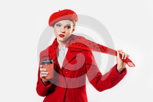 young beautiful fashionable woman wearing stylish winter red coat, silk scarf, red beret on a white in studio. Copy