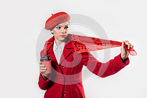 young beautiful fashionable woman wearing stylish winter red coat, silk scarf, red beret on a white in studio. Copy