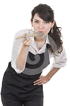 Young beautiful female chef wearing black apron