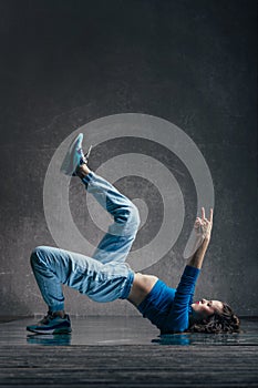 Young beautiful female dancer is posing in the studio