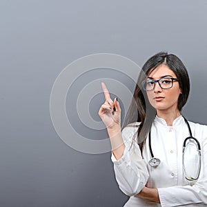 Young beautiful female doctor showing blank area