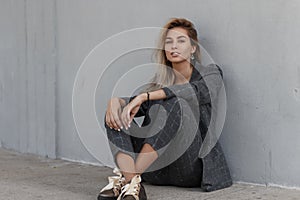 Young beautiful female fashion model in gray strict jacket