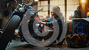 Young Beautiful Female Mechanic is Working on a Custom Bobber Motorcycle. Talented Girl Wearing a