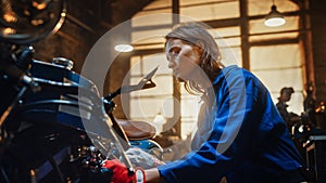 Young Beautiful Female Mechanic is Working on a Custom Bobber Motorcycle. Talented Girl Wearing a