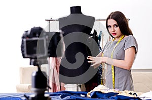 The young beautiful female tailor recording video for her blog