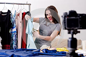 Young beautiful female tailor recording video for her blog