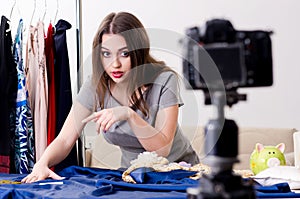 Young beautiful female tailor recording video for her blog