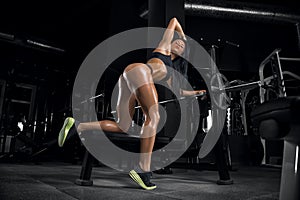 Young beautiful fitness girl posing in the gym