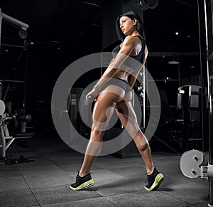 Young beautiful fitness girl posing in the gym