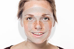 Young beautiful freckles woman face portrait with healthy skin