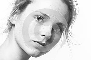 Young beautiful freckles woman face portrait with healthy skin b