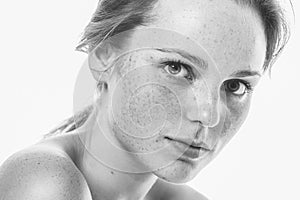 Young beautiful freckles woman face portrait with healthy skin b