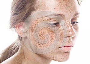 Young beautiful freckles woman face portrait with healthy skin