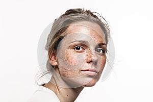 Young beautiful freckles woman face portrait with healthy skin