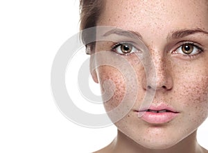 Young beautiful freckles woman face portrait with healthy skin