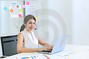 Young beautiful friendly operator woman with headset working in a call center. customer service pay attention and talking to