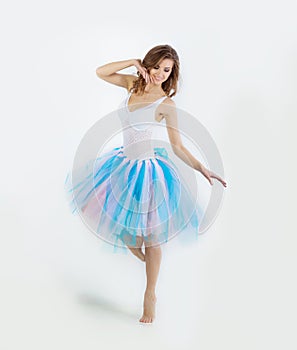 Young beautiful gentle girl dancer posing on white background Studio
