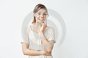 Young beautiful girl ashamed looking at camera over white background.