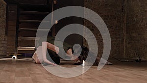 Young beautiful girl ballerina is dancing, spining, stairs on background, lights on floor, ballet concept, movement