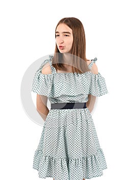 Young beautiful girl in a blue dress with polka dots on a white background