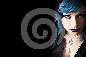 Young beautiful girl blue hair and make-up. Free left space black background