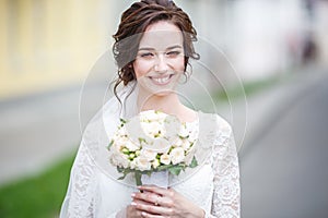 Young beautiful girl bride in a peignoir standing city street waiting for the groom