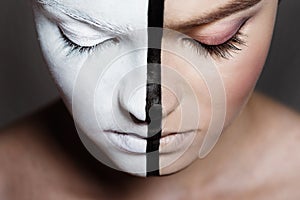 young beautiful girl with closed eyes and creative bodyart on half of face,