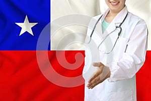 Young beautiful girl doctor with an open smile holds out his hand for greeting on the background of the national flag, concepts of