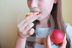 young beautiful girl eating an apple, close-up