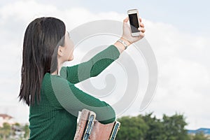 Young beautiful girl. Elated pretty girl selfie while sit chair