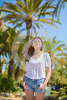 Young beautiful girl enjoying sunny day in Cannes