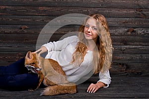 A young beautiful girl holding a wild fox animal that was traumatized by a man and rescued by her and now lives as before