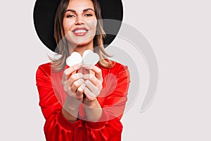 Young beautiful girl holding wooden hearts and smiling on Valentine`s day, copyspace