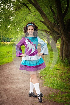 Young beautiful girl in irish dance dress posing outdoor