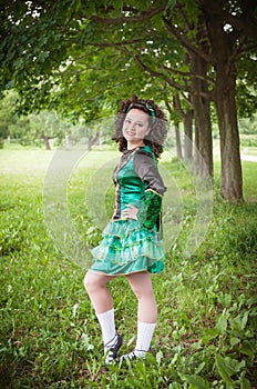 Young beautiful girl in irish dance dress posing outdoor