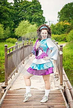 Young beautiful girl in irish dance dress and wig having fun