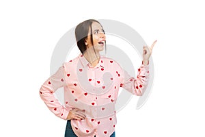 Young, beautiful girl isolated on a white background, points his fingers at the place for promo, offers or advertising