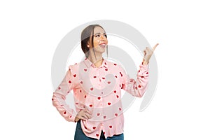 Young, beautiful girl isolated on a white background, points his fingers at the place for promo, offers or advertising