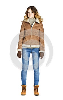 Young beautiful girl in a leather sheepskin coat and blue jeans