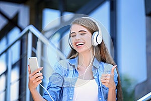 Young beautiful girl listening music