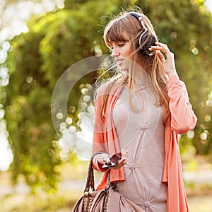 Young beautiful girl listening to MP3 player